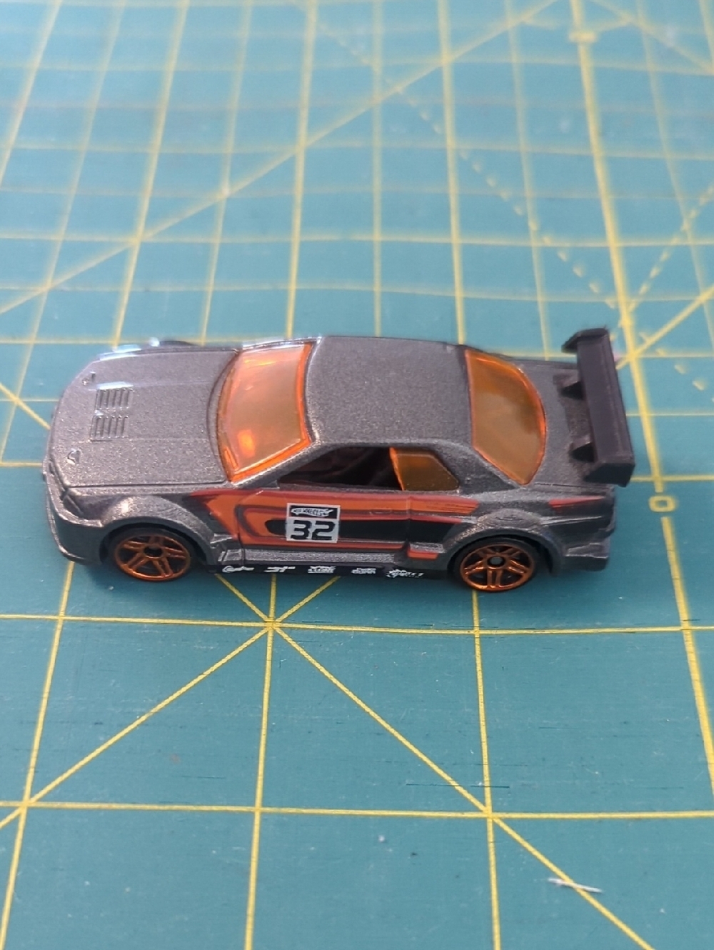 2010 Hot Wheels Mystery CarDie-Cast Race Car Toy - Gray with Orange Accents